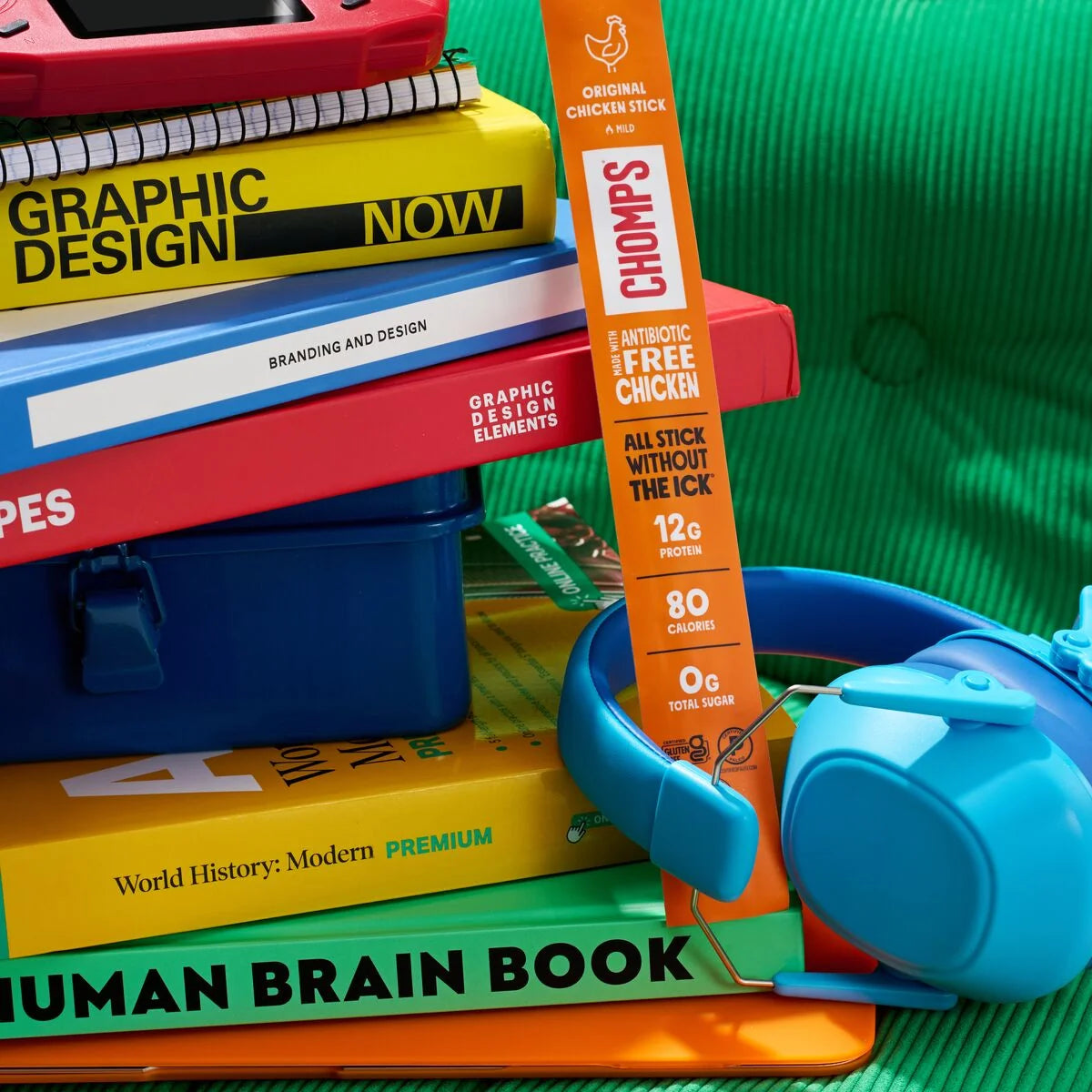 Chomps snack beside a stack of books